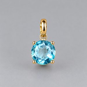 Colgante dorado con gema azul facetada